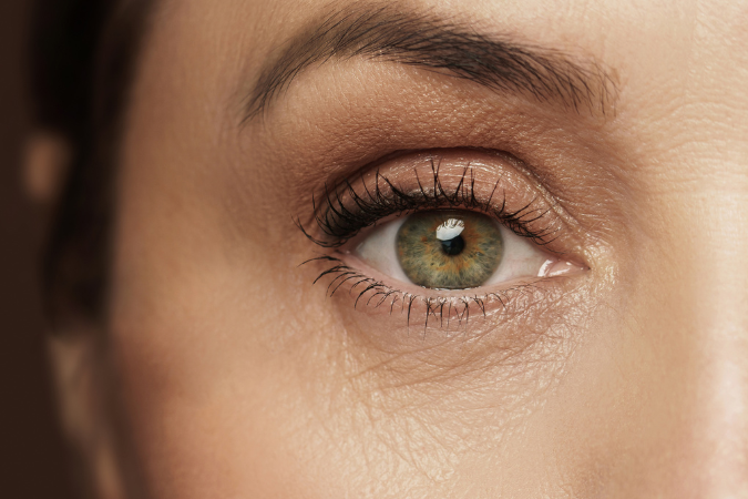 Close-up of a person's eye with a neutral background
